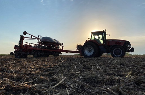 tractor in stubble pulling a sprayer